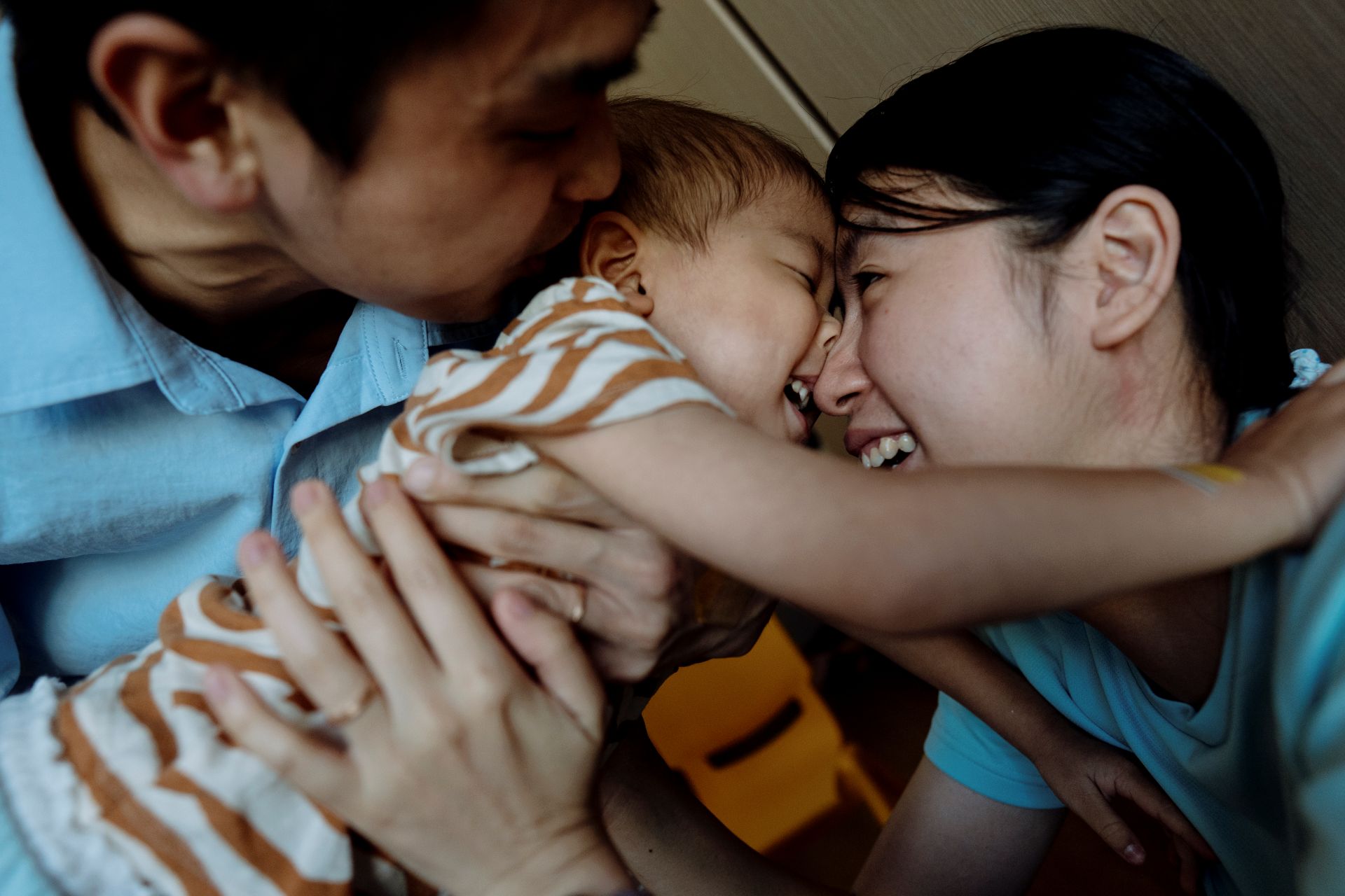 Family Hugging And Laughing